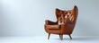© AkuAku - A comfortable club chair with a brown leather hair rests in front of a white wall, adding warmth and elegance to the room's decor.