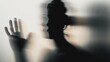 © Vladimir - Woman silhouette on grey background. Blurred human hand shape out of focus. Mysterious female portrait.