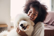 Smiling black woman with dog
