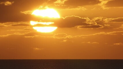 Wall Mural - beautiful evening sunset in the atlantic ocean at portugal coast. red big sun setting down in the oc