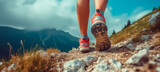 Fototapeta  - low angle view of legs with sports shoes running on a mountain on summer day , trekking or trail run concept image