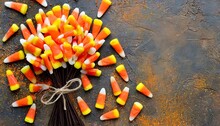 Bunch Of Candy Corn Sweets As Sybol Of Halloween Hoiday On Textured Background With A Lot Of Copy Space For Text Flat Lay Composition For All Hallows Eve Top View Shot