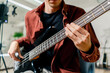 © Guys Who Shoot - musician with electric guitar in recording studio plays musical instrument presses fingers on strings close-up