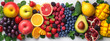 Horizontal background of bright fruits. Ripe fruits apples, bananas, grapes, kiwi, avocado, raspberry on a stone background. Copy space.