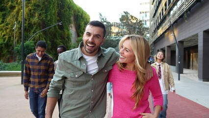 Wall Mural - Happy friends laughing at camera together - University students walking in college campus - Friendship life style concept