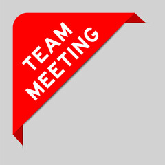 Sticker - Red color of corner label banner with word team meeting on gray background