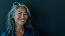 Happy Smiling Stylish Confident 50 Years Old Asian Female Professional Standing Looking At Camera At Gray Background. Portrait Of Sophisticated Grey Hair Woman Advertising Products.