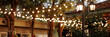 © Kaplitskaya Love - Illuminated restaurant entrance during a wedding. Romantic and welcoming atmosphere. Concept: wedding venue showcasing, event planning. Banner with copy space.