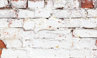 White brick wall background with cracked paint. Old white brick wall texture. Abstract white brick wall wallpaper. Close up.