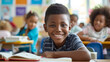 © Taisiia - Happy African student sitting in class with classmates at desk