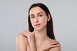 © New Africa - Portrait of beautiful young woman on light grey background