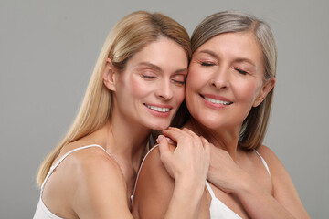 Wall Mural - Beautiful women with healthy skin on gray background