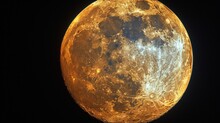 A Close Up Of A Large Yellow Moon In The Night Sky With A Black Sky In The Back Ground And A Black Sky In The Background.
