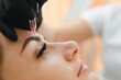Process of creating permanent brow makeup with a machine at beauty salon