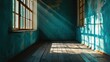 Sunlight streams through windows in an old room with peeling teal paint