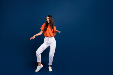 Poster - Full length photo of funky adorable woman dressed orange t-shirt dancing discotheque empty space isolated dark blue color background