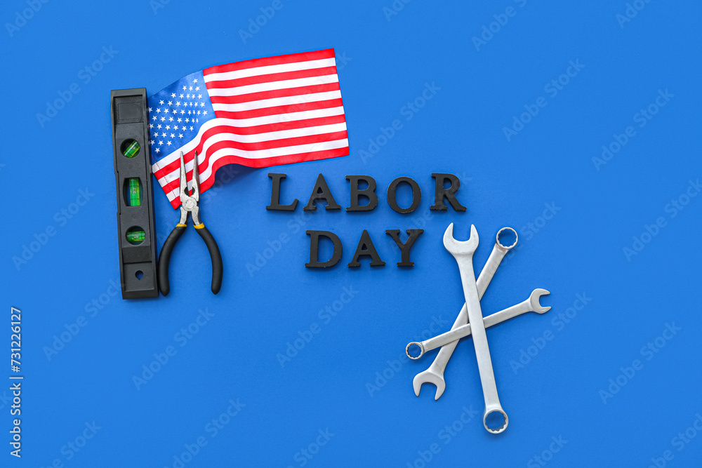 Different tools, USA flag and text LABOR DAY on blue background