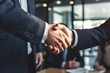 © ProPhotos - Close-up of businessmen's hands in a strong handshake, symbolizing success and teamwork in a corporate environment.