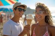 © Pinklife - A couple shares a sweet moment on the beach, with the woman smiling and holding a delicious ice cream cone while wearing stylish sunglasses and standing next to her partner in fashionable clothing an