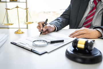 Wall Mural - Male lawyer or judge working with contract papers, Law books and wooden gavel on table in courtroom, Justice lawyers at law firm, Law and Legal services concept