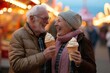 Joyful senior couple enjoying a romantic moment Laughing and eating ice cream at a vibrant amusement park. celebrating life and love in their golden years