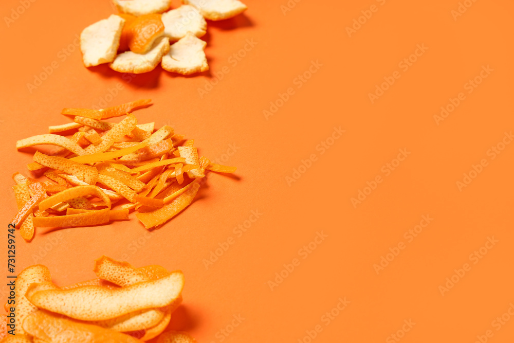 Heaps of fresh orange peel on color background
