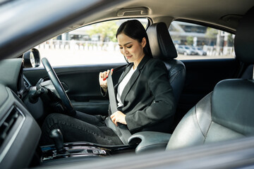 Wall Mural - Young beautiful asian business women getting new car put on safety belt. she very happy and excited sit and put on seatbelt. Smiling female buying new car safety driving vehicle on the road