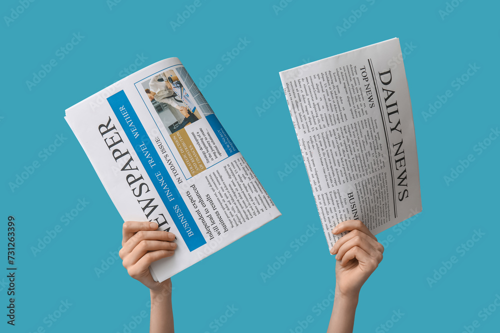 Woman with newspapers on blue background