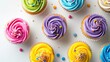 Colorful cupcakes arranged on a white background