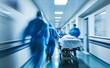 © Tida - A motion-blurred image capturing the urgency of a medical team in scrubs swiftly moving a patient on a stretcher through a hospital corridor.
