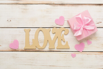 Wall Mural - Valentines day composition with gifts on wooden background, top view.