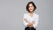 © Studio Nova - woman with short blonde hair and a confident smile is wearing a white shirt and stands with her arms crossed against a light grey background