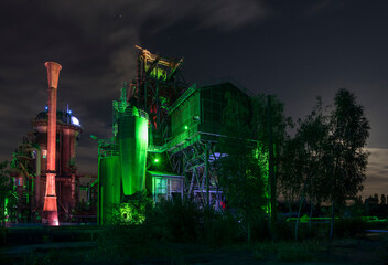 Illuminated steel factory at night.