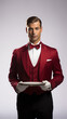 © Etagonam - Butler holding a silver tray isolated on white. Concierge. Waiter. Butler in red tuxedo. Casino staff. Hotel staff. Handsome male. Casino butler. Casino concierge. Male waiter in uniform. Casino host.