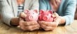 Senior couple s hands holding pink piggy bank  shared commitment to retirement savings and pension