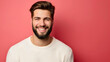 © Nemanja - Young Caucasian man standing, smiling and looking at the camera. Happy youthful male model studio photography, isolated on red background, one pretty guy posing