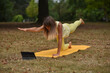 © Natalje Dietrich - A middle-aged woman is doing yoga in the park