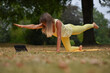 © Natalje Dietrich - A middle-aged woman is doing yoga in the park