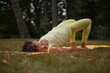 © Natalje Dietrich - A middle-aged woman is doing yoga in the park