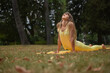 © Natalje Dietrich - A middle-aged woman is doing yoga in the park