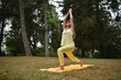 © Natalje Dietrich - A middle-aged woman is doing yoga in the park