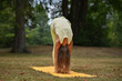 © Natalje Dietrich - A middle-aged woman is doing yoga in the park