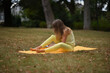 © Natalje Dietrich - A middle-aged woman is doing yoga in the park