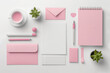  Feminine workspace desk with minimal pastel pink stationery set. Flat lay, top view.