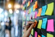 © Radomir Jovanovic - A person's artistic expression comes to life on a blackboard, adorned with colorful post-it notes, creating a vibrant and captivating street scene indoors