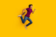 © deagreez - Profile side photo of cheerful nice man wear trendy polo running hurrying sale empty space isolated on yellow color background