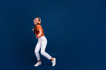 Sticker - Full length photo of pretty cute lady wear orange t-shirt headphones enjoying discotheque empty space isolated dark blue color background