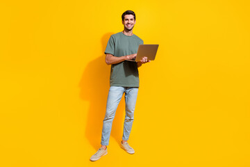 Aufkleber - Full length photo of cheerful good mood guy wear khaki t-shirt working modern device isolated yellow color background