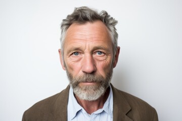 Wall Mural - Portrait of a senior man with grey hair and beard looking at camera