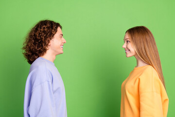 Sticker - Profile photo of two cheerful nice people toothy smile look each other isolated on green color background